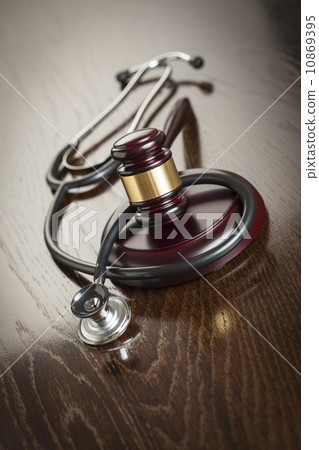 Gavel and Stethoscope on Reflective Table 10869395