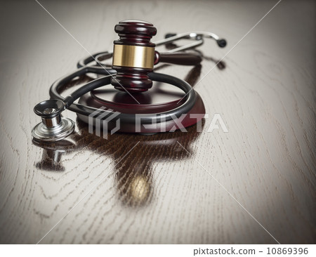 Gavel and Stethoscope on Reflective Table 10869396