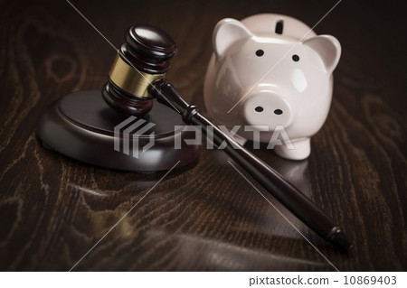 Gavel and Piggy Bank on Table 10869403