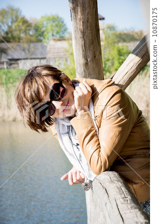 Beautiful woman on a pier at the lake 10870175