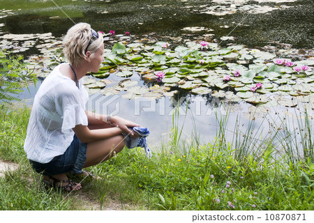 Beautiful woman near the lake 10870871