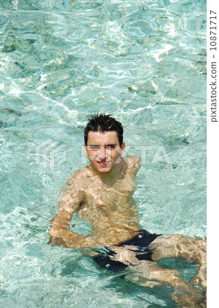 Young man relaxing and smiling in Maldives (ocean background) Young man relaxing and smiling in Maldives (ocean background) 10871717