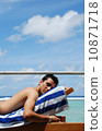 Young man sunbathing in a Maldives resort room 10871718
