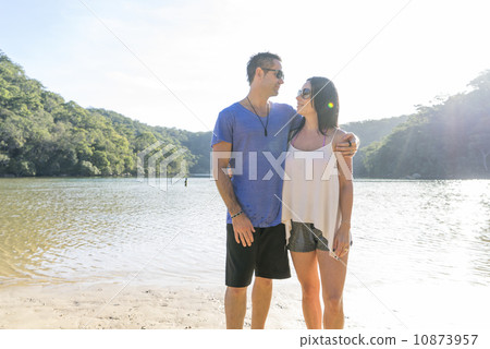 A caucasian couple is enjoying their time together by the beach.  10873957