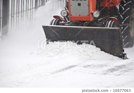 Tractor removes snow Tractor removes snow 10877063