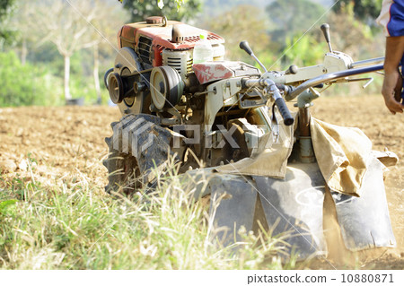 Farmer drilling soil for prepare to do vegetable Farmer drilling soil for prepare to do vegetable 10880871