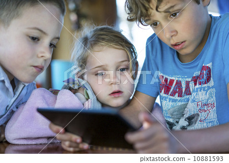 Caucasian children playing games on tablet computer 10881593