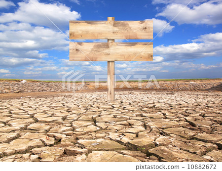 Old wooden sign on the parched ground 10882672