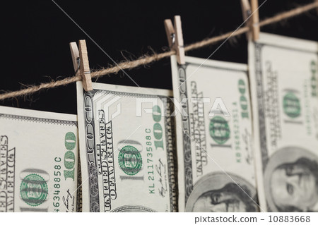 Hundred Dollar Bills Hanging From Clothesline on Dark Background Hundred Dollar Bills Hanging From Clothesline on Dark Background 10883668