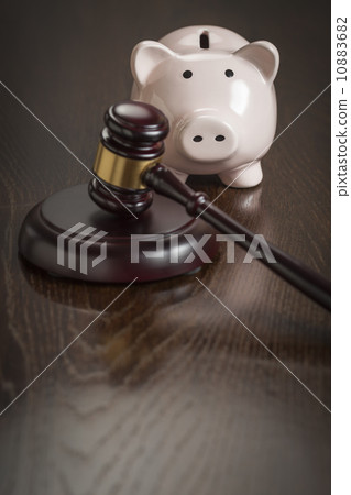Gavel and Piggy Bank on Table 10883682