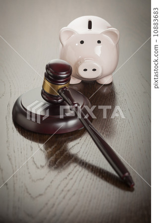 Gavel and Piggy Bank on Table 10883683