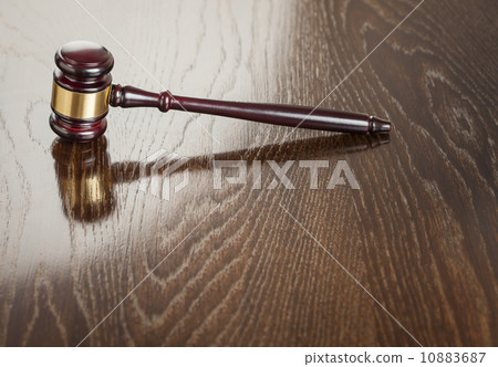 Wooden Gavel Abstract on Reflective Table 10883687