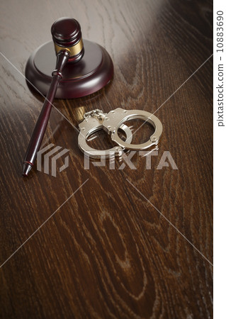 Gavel and Pair of Handcuffs on Table 10883690