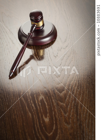 Wooden Gavel Abstract on Reflective Table 10883691