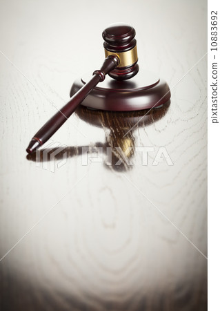 Wooden Gavel Abstract on Reflective Table 10883692
