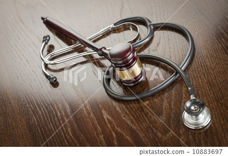 Gavel and Stethoscope on Reflective Table 10883697