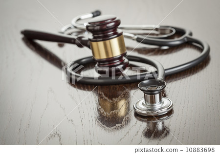 Gavel and Stethoscope on Reflective Table 10883698