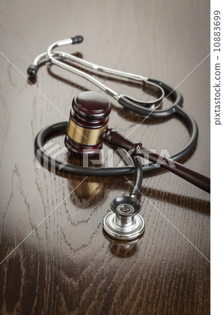 Gavel and Stethoscope on Reflective Table 10883699