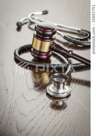 Gavel and Stethoscope on Reflective Table 10883701