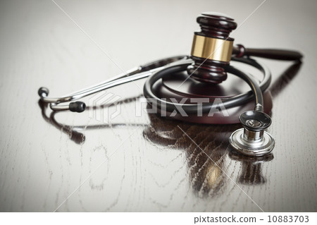 Gavel and Stethoscope on Reflective Table 10883703