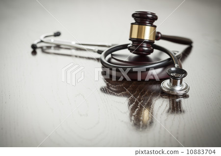 Gavel and Stethoscope on Reflective Table 10883704
