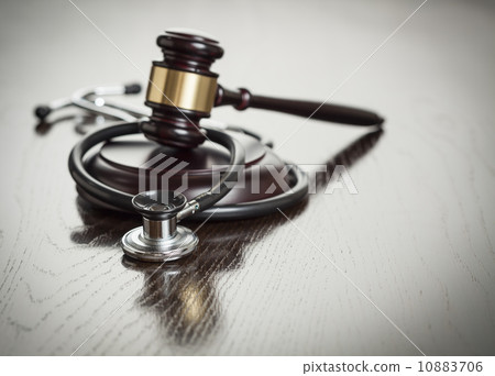 Gavel and Stethoscope on Reflective Table 10883706