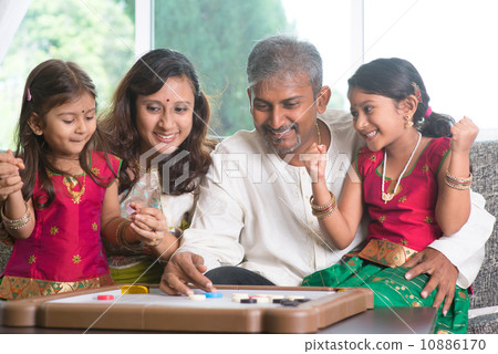 Happy Indian family playing carrom game 10886170