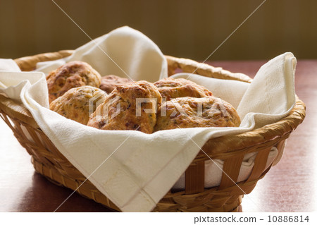Homemade scones in a wicker basket Homemade scones in a wicker basket 10886814