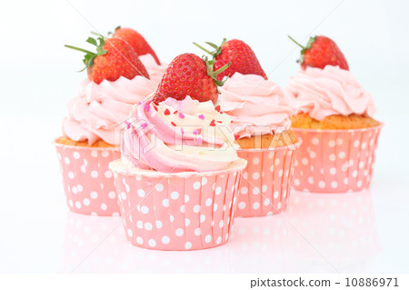 Delicious vanilla cupcake with strawberry frosting and fresh strawberry 10886971