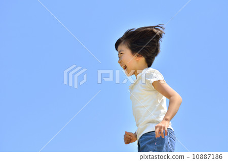 A girl running in the blue sky A girl running in the blue sky 10887186