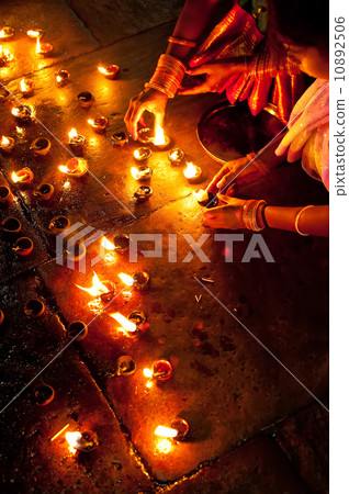 People burning oil lamps as religious ritual in Hindu temple 10892506