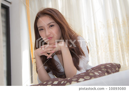 Asian woman in the bedroom. 10893080