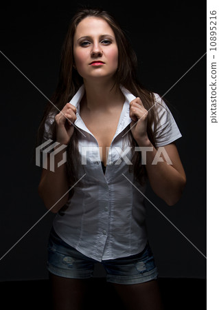 Serious woman in shirt looking at camera Serious woman in shirt looking at camera 10895216