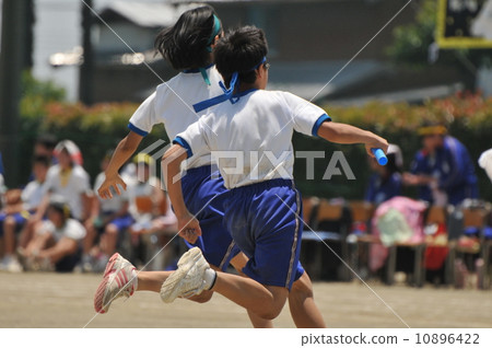 Runners competing in a relay race at a sports festival Runners competing in a relay race at a sports festival 10896422