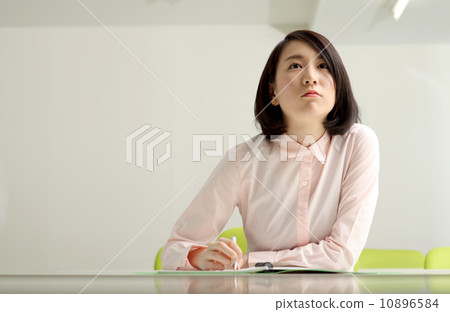 A woman taking a note in the classroom A woman taking a note in the classroom 10896584
