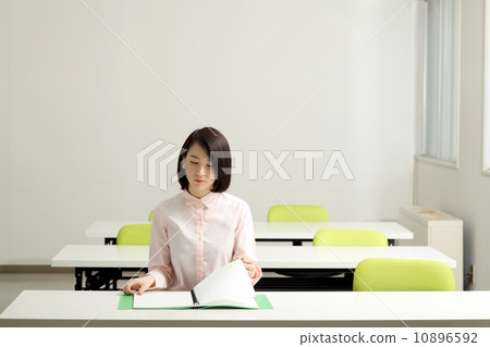 A woman taking a note in the classroom A woman taking a note in the classroom 10896592