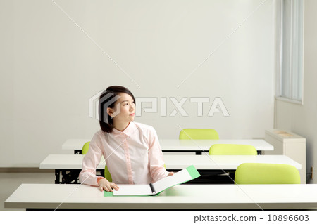 A woman taking a note in the classroom A woman taking a note in the classroom 10896603