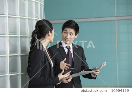 Asian Business people reading electronic tablet and newspaper. Asian Business people reading electronic tablet and newspaper. 10904129