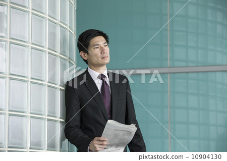 Asian businessman holding newspaper. Asian businessman holding newspaper. 10904130