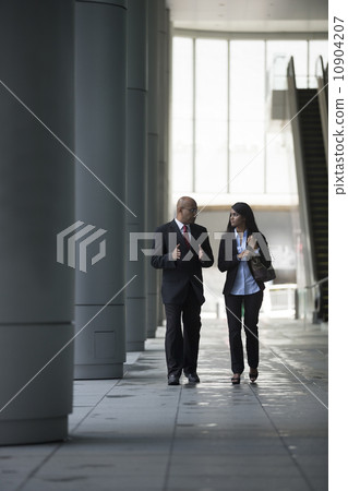 Happy Indian Business colleagues walking outside office. 10904207