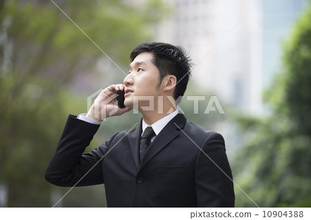 Chinese business man using a smartphone. Chinese business man using a smartphone. 10904388