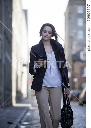 Modern Business woman, talking on mobile phone outside. Modern Business woman, talking on mobile phone outside. 10904507