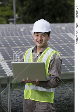 Asian engineers checking solar panel setup Asian engineers checking solar panel setup 10904748