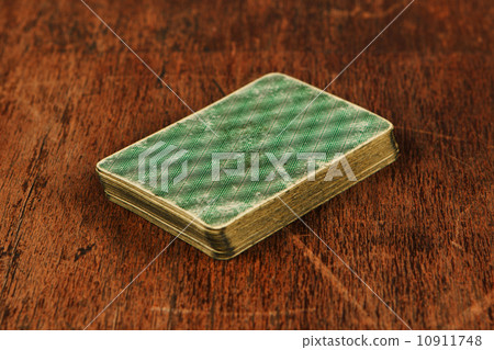 deck of old cards on wooden table 10911748
