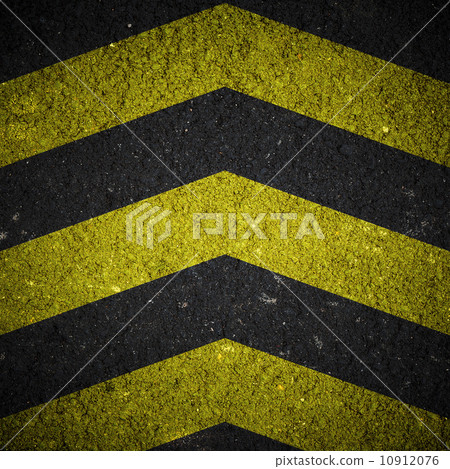 Yellow and black warning sign on asphalt texture 10912076