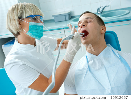 woman dentist working on patient teeth 10912667
