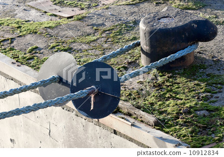 mooring bollard with nautical ropes and anti rat devices 10912834