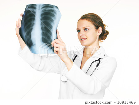 female doctor examining an X-ray female doctor examining an X-ray 10913469