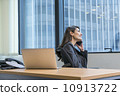 Asian executive in a jacket making a call in the office. Asian executive in a jacket making a call in the office. 10913722