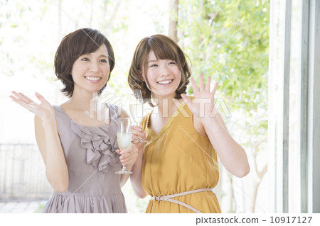 Two women with champagne glasses Two women with champagne glasses 10917127